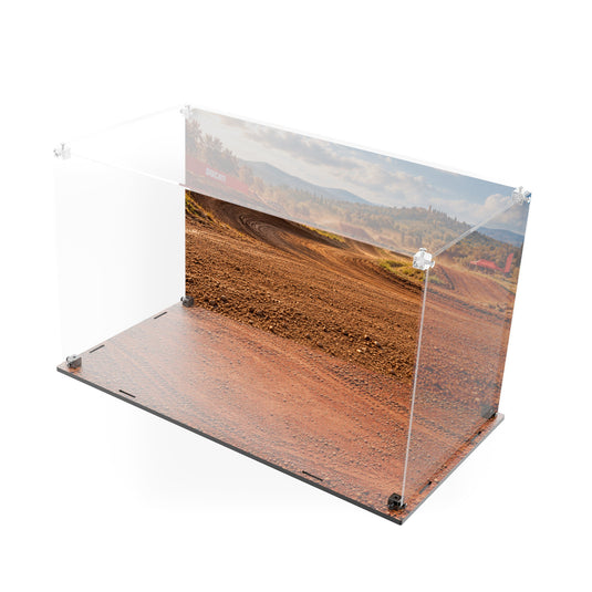 Empty Ducati Desmo450 MX acrylic display case with printed motocross backdrop and base, viewed from above